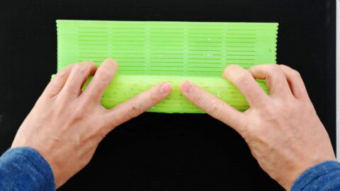 Compressing sushi roll with mat.