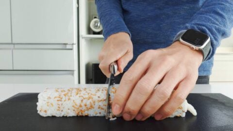 Slicing California Sushi Roll.