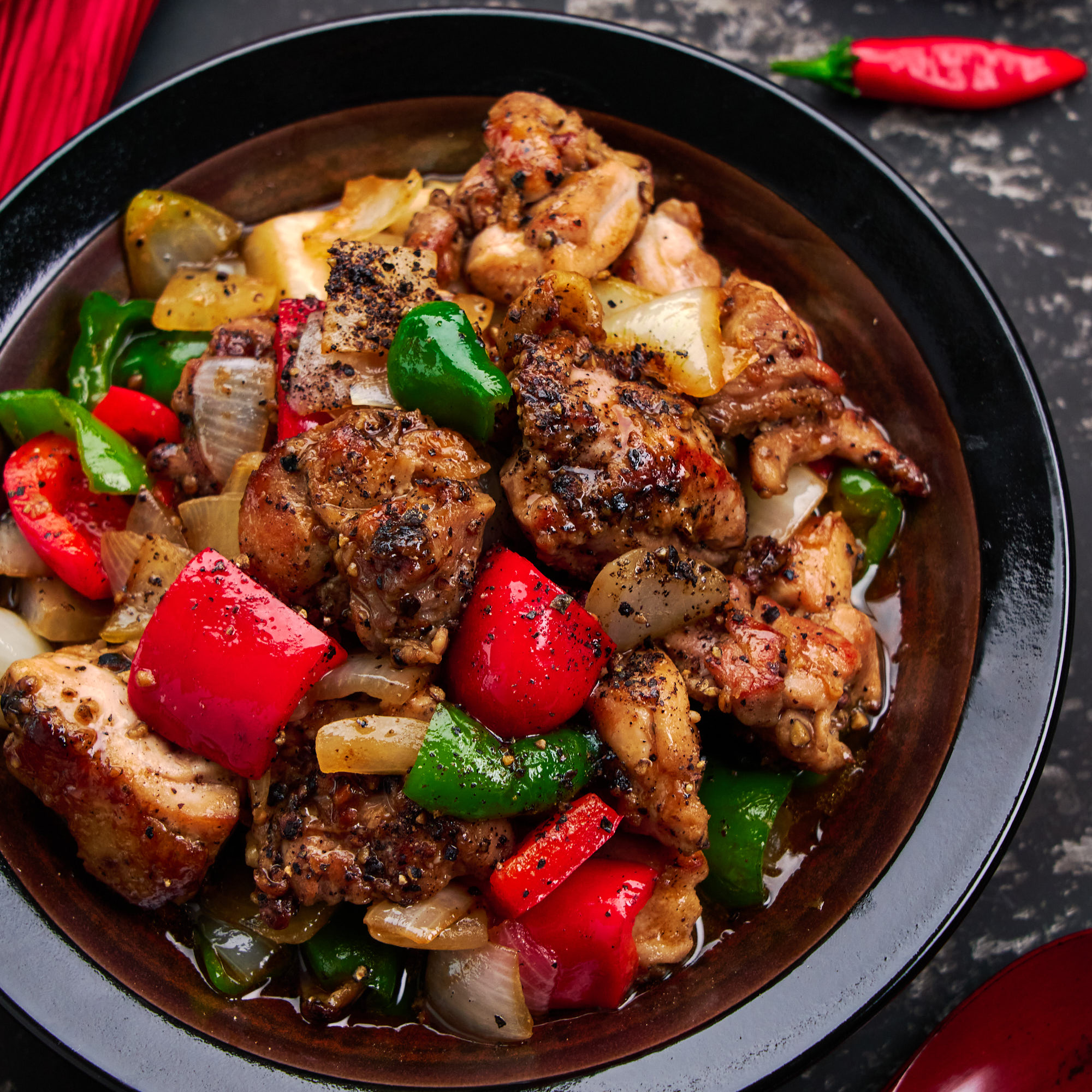 This easy stir-fry recipe makes a mouthwatering bowl of spicy chicken with black pepper sauce in a matter of minutes.