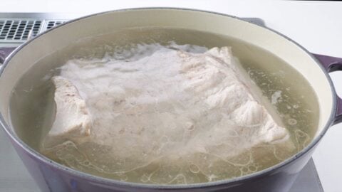 Parboiling pork belly.