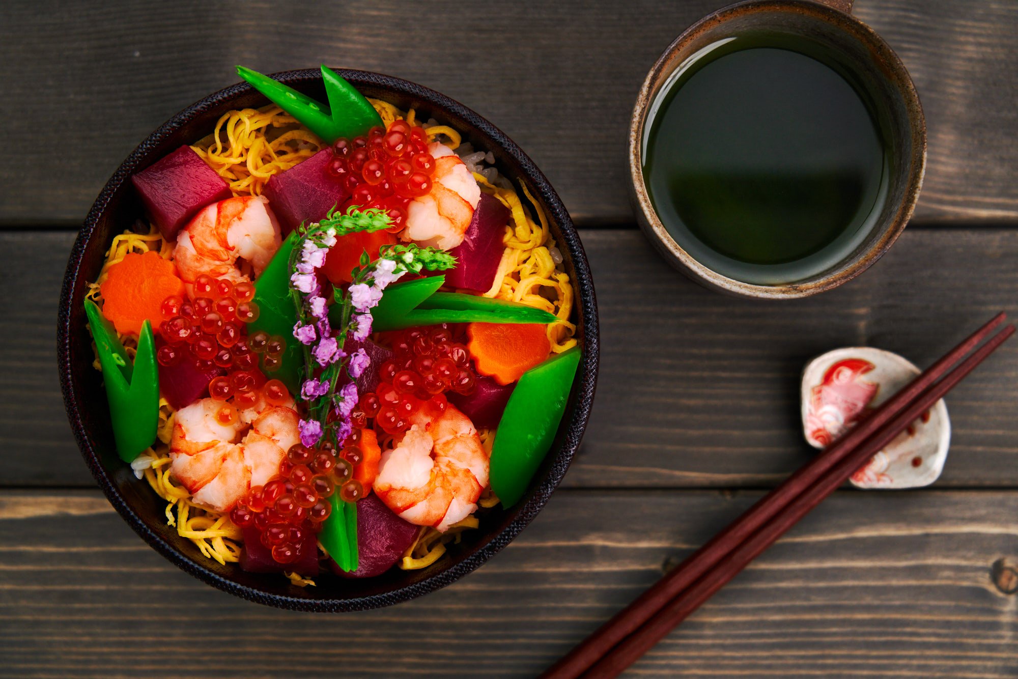 Chirashi Sushi means "scattered sushi" and as the name implies the toppings are scattered on top of a bowl of sushi rice.
