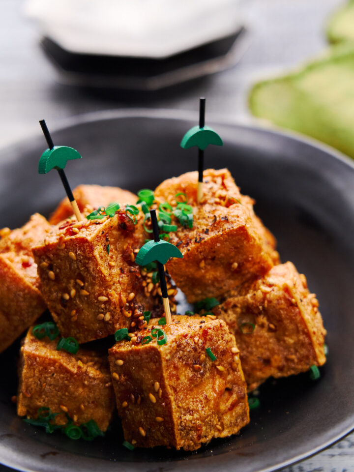 Ultra-crispy on the outside and tender and juicy on the inside these Crispy Tofu Bites are glazed with a savory sweet sauce that's loaded with ginger, garlic and black pepper. The perfect plant-based appetizer.