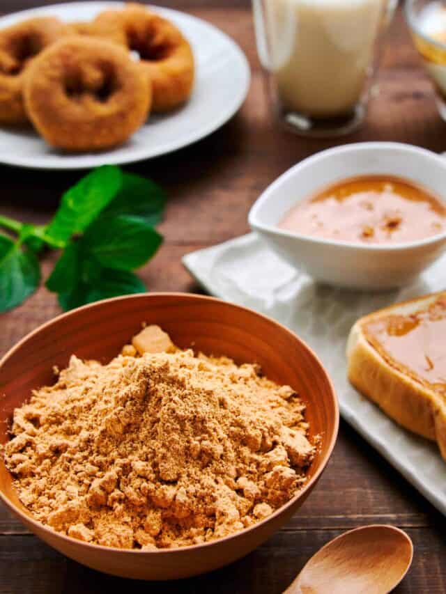 A vibrant spread featuring a bowl of kinako, kinako-dusted doughnuts, kinako butter on toast, and a kinako latte, illustrating the myriad uses of this traditional Japanese ingredient.
