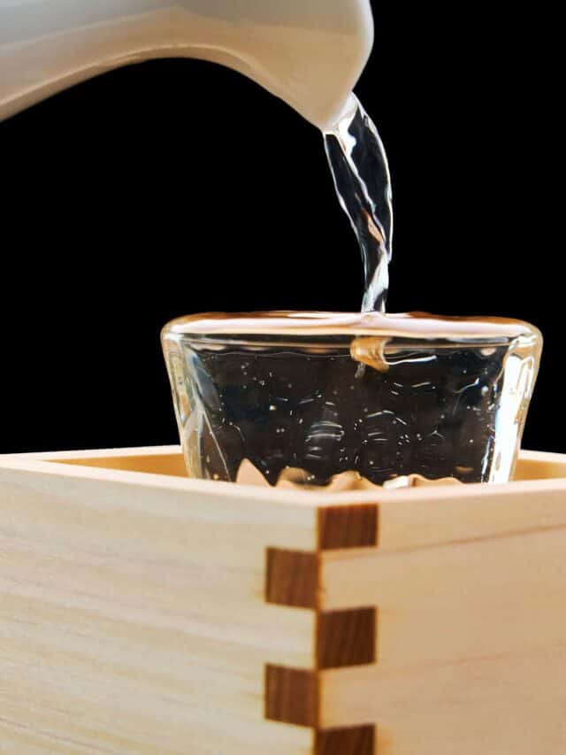 Masuzake overflowing from a glass. This traditional beverage is also an important ingredient in Japanese cooking.