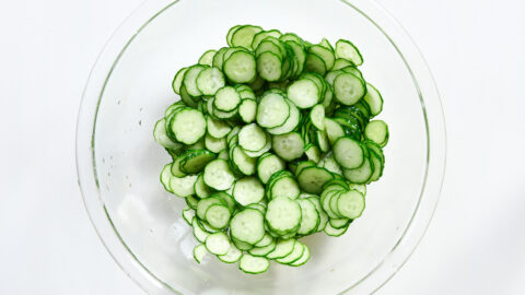 Thinly sliced Japanese cucumbers salted and resting.