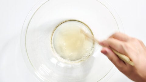 Chopsticks stir a simple sunomono sauce, combining sweet, salty, and tangy notes into a bright vinaigrette.