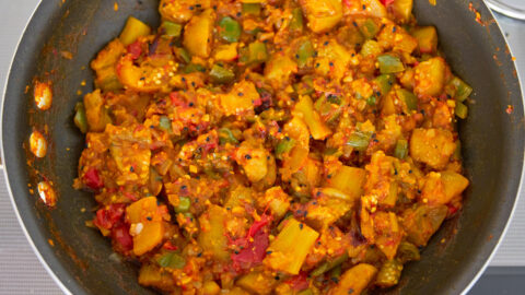 Finished eggplant curry is vibrant both in color and taste with tender eggplant pungent spices and tangy tomatoes.