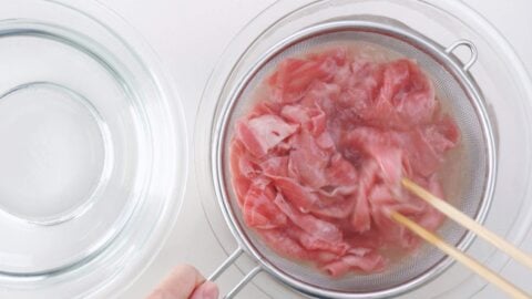 Blanching A5 Wagyu beef in boiling water.