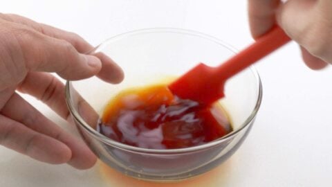 Making honey teriyaki sauce in a bowl.