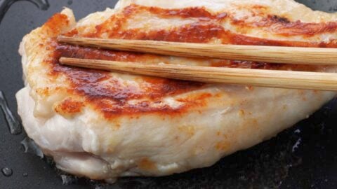 Pressing on the thicker side of the breast with chopsticks.