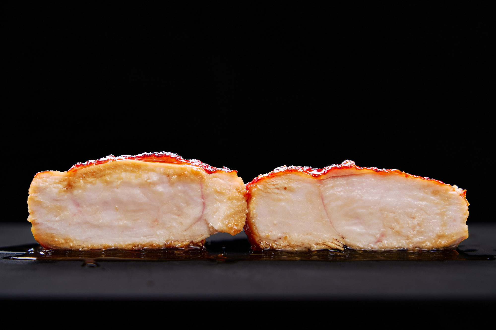 Cross section of a juicy chicken breast glazed with honey teriyaki sauce.