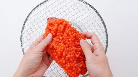 Splitting a skein of salmon roe.