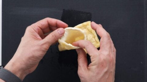 Opening up fried tofu pocket.
