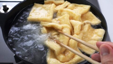 Boiling tofu wrappers in water.