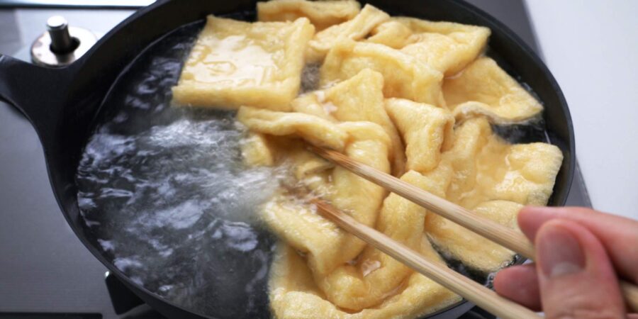 Boiling tofu wrappers in water.