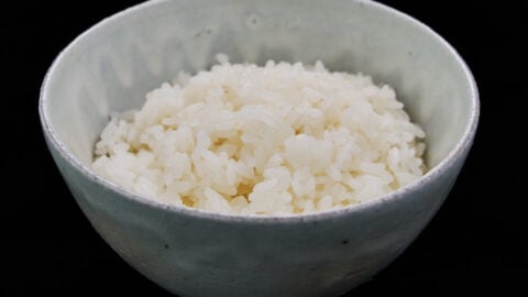A bowl of steaming-hot, fluffy Japanese short-grain rice waiting to be transformed into buttery deliciousness.