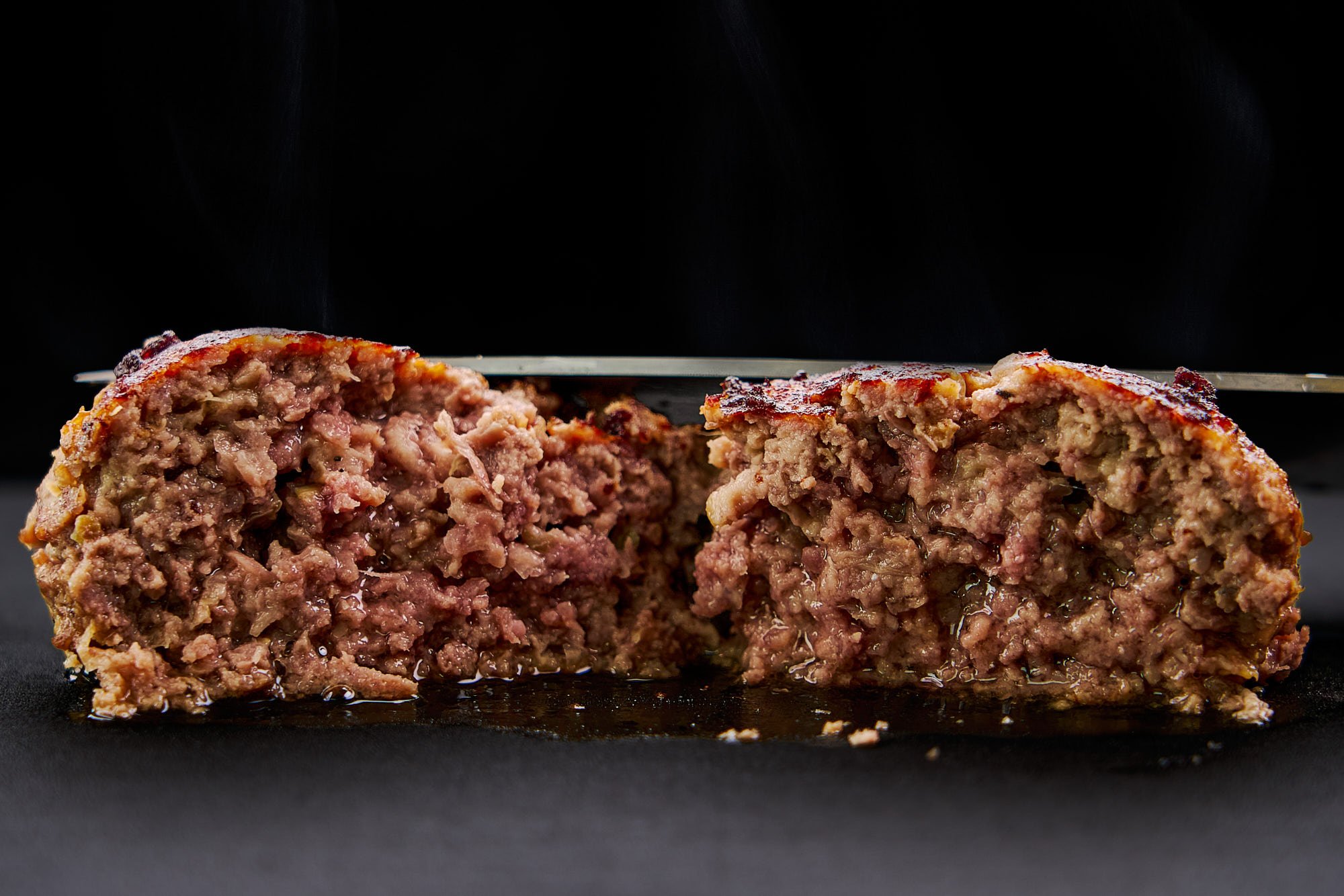 Cross section of a Japanese hamburg steak made with 3 culinary tricks to make it extra juicy.