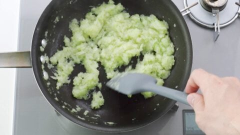 Evaporating excess liquid from the steamed cabbage and onions.