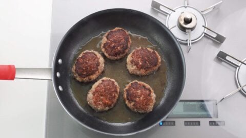 Steamed hamburg steaks in a frying pan.