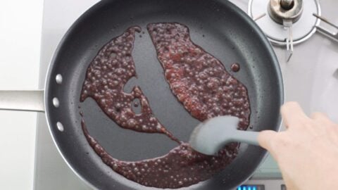Deglazing frying pan with red wine.