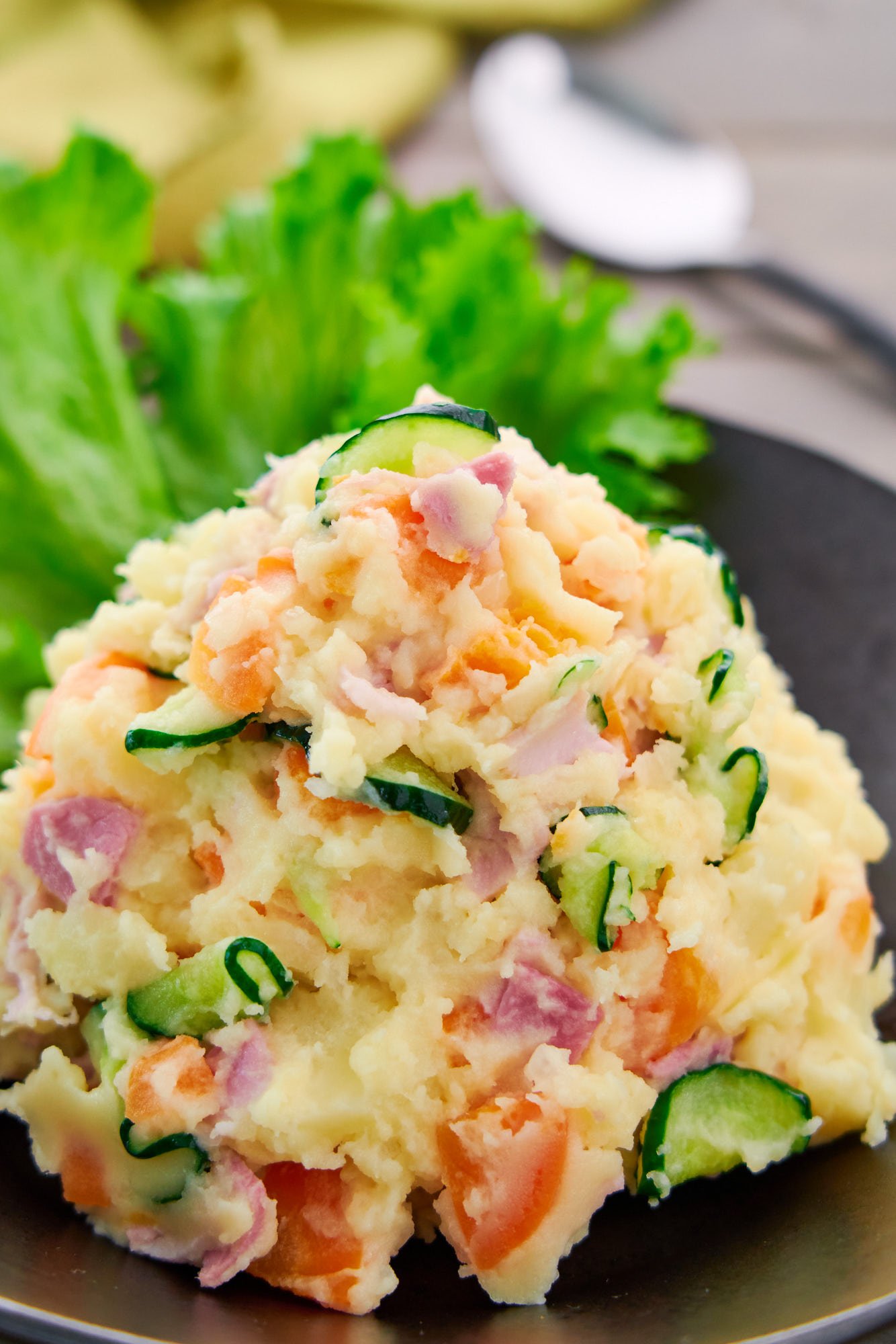 Japanese style potato salad is loaded with colorful ingredients like crunchy cucumbers, crisp onions, and savory ham.