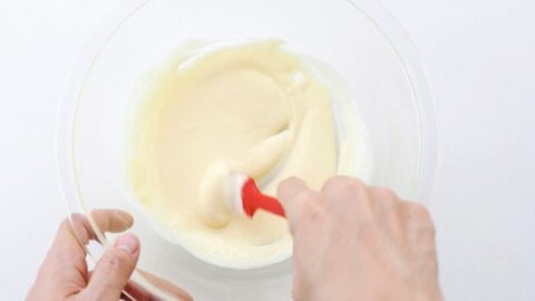 Mixing mayonnaise and sushi vinegar to make dressing.