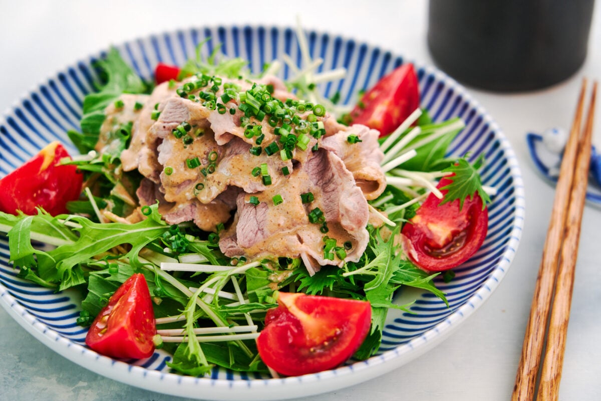 Japanese sesame sauce (Goma Dare) drizzled over shabu shabu pork and salad greens.