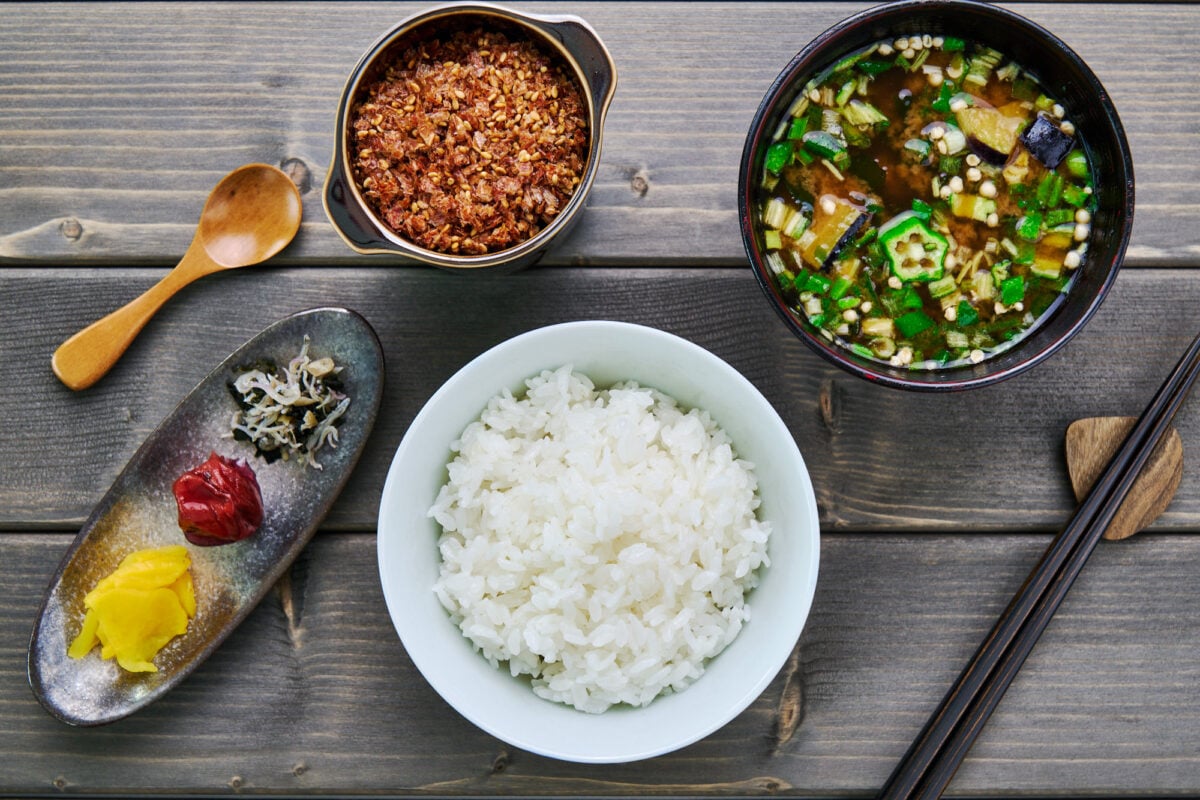 Japanese breakfast spread with rice, pickles, furikake and miso soup.