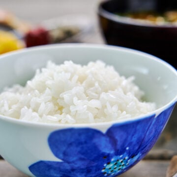 Glistening Japanese short-grain rice in a blue flower bowl.