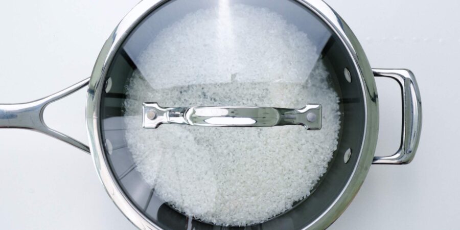 Japanese short-grain rice soaking in water before cooking.