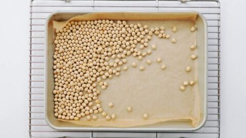 Cooling roasted soybeans on a wire rack.