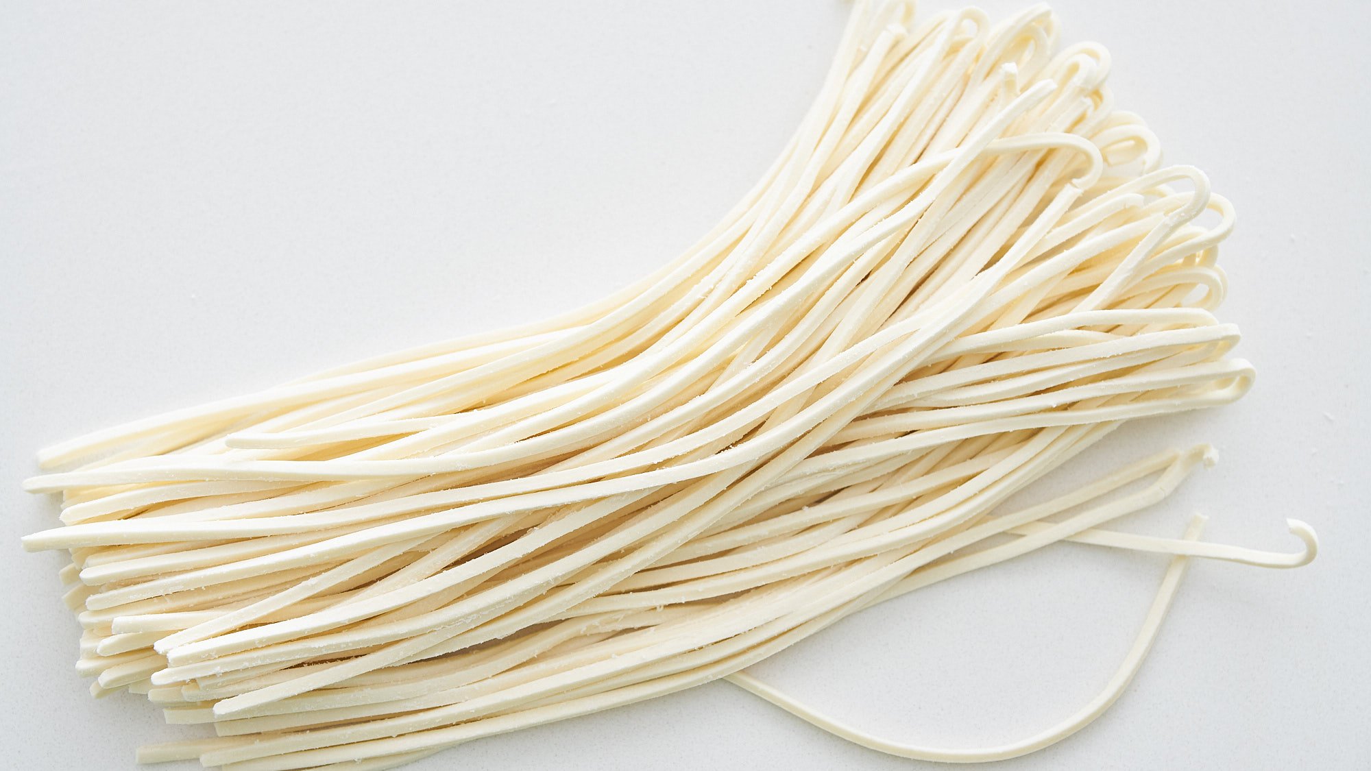 Fresh udon noodles ready to be boiled.