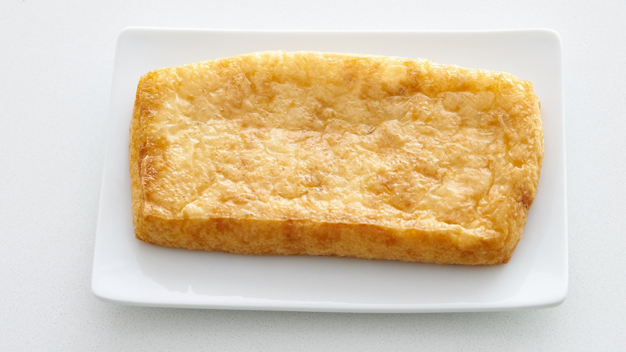 A block of aburaage (fried tofu).