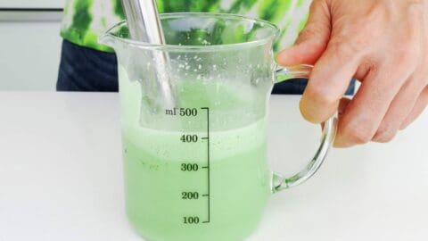 Whisking matcha latte with an immersion blender.