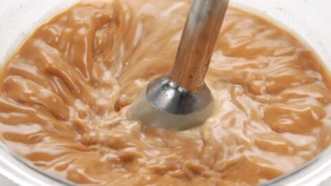 Emulsifying ramen base with miso and butter.