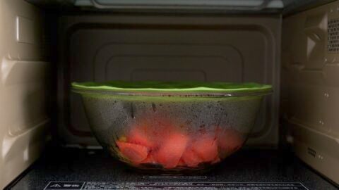 Carrots and potatoes microwaved in a glass bowl to speed up the cook time for Nikujaga.