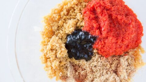 Bread crumbs, peppers, and pepper paste in a bowl.