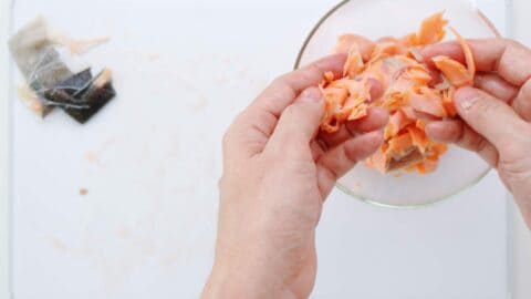 Flaking salted salmon.