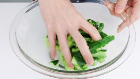 Salting smashed cucumbers.
