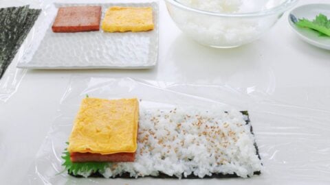 Adding Spam and egg topping to Onigiri.