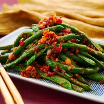 Mound of green beans stir fried with garlic and chili paste. An easy vegan Chiense stir-fry.