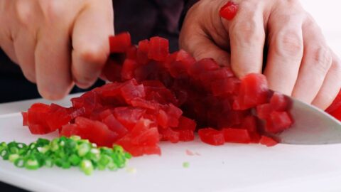 Mincing tuna for spicy tuna rolls