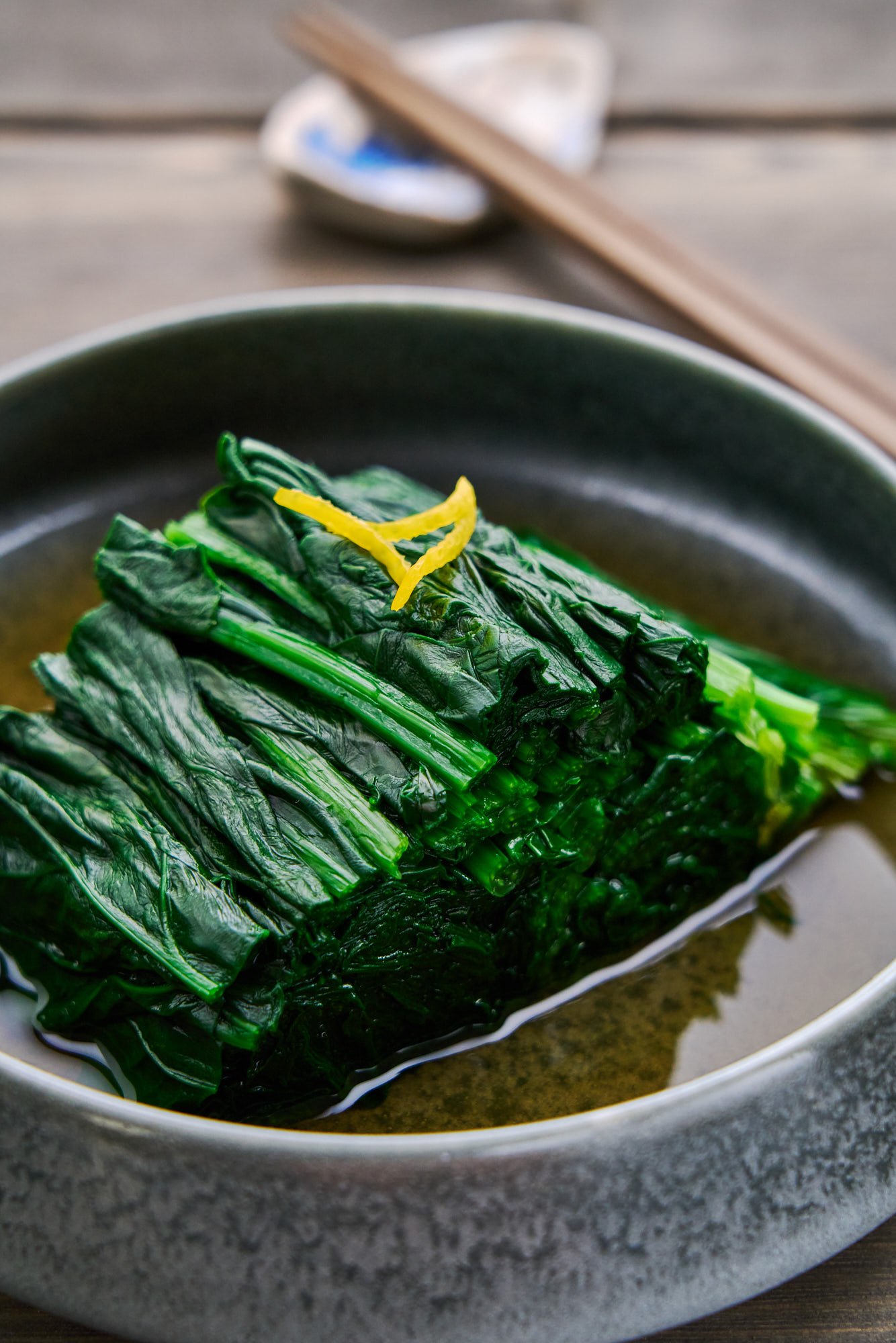A bowl of Spinach Ohitashi, a Japanese salad made by blanching spinach and infusing it with an umami-rich dashi marinade.