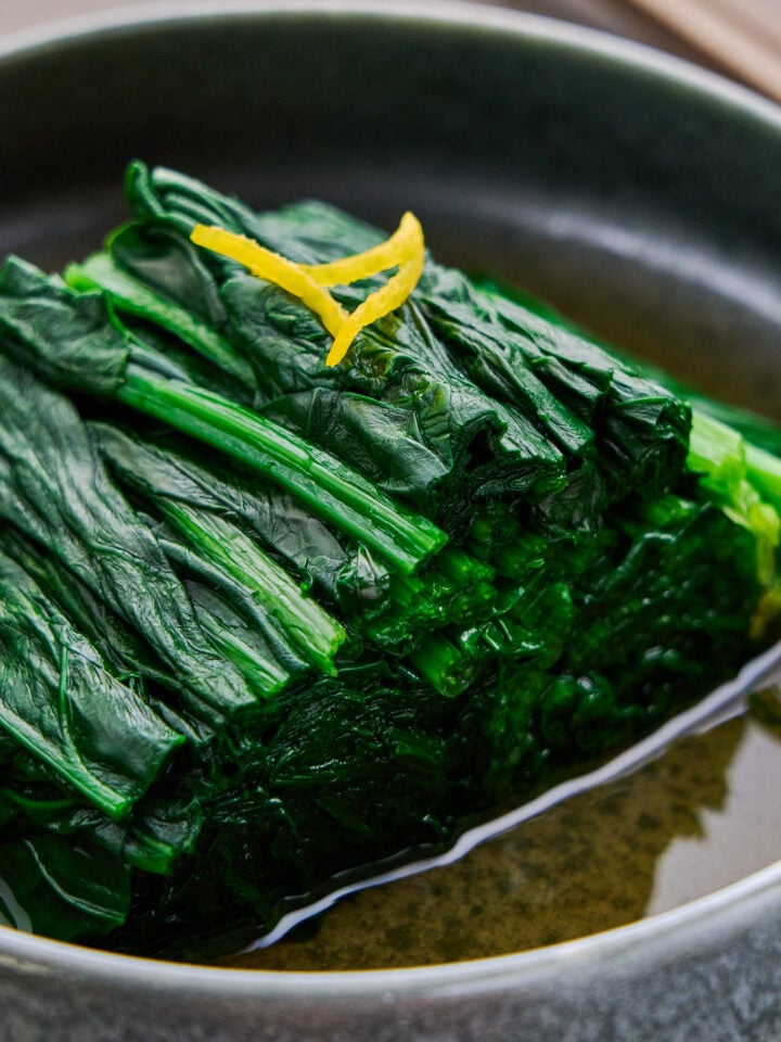 A bowl of Spinach Ohitashi, a Japanese salad made by blanching spinach and infusing it with an umami-rich dashi marinade.
