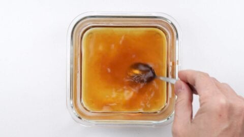 Mixing dashi broth in a square container.
