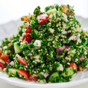 Mounded high on a scalloped plate, the parsley and bulgur salad reveals pops of ruby tomato, pale cucumber, and flecks of onion against the vivid green herbs.
