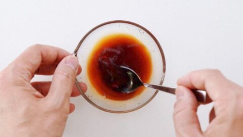 Mixing teriyaki sauce in a glass bowl.