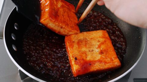 Glazing tofu steaks with Japanese steak sauce.