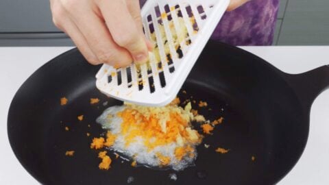 Grating garlic, ginger, onions and carrots.