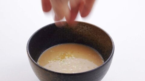 Serving ramen dipping sauce in a bowl.